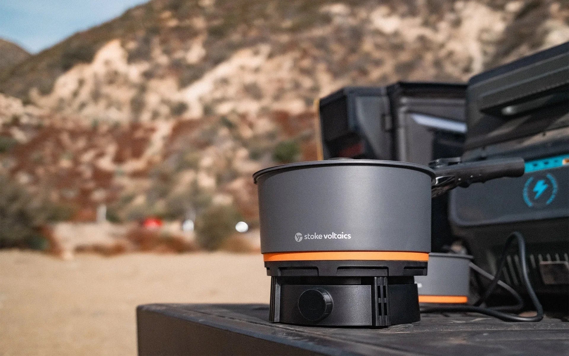 Stoke Voltaics all-purpose kettle pot and cooking system on outdoor table in wilderness.